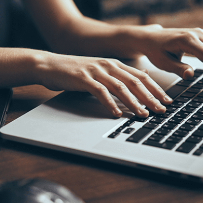 Teams - Person typing on laptop keyboard